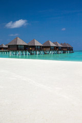 beach with water bungalows at Maldives