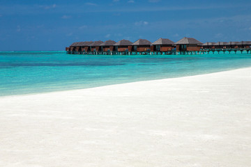 beach with water bungalows at Maldives