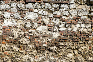 Irregular wall of bricks and stones.