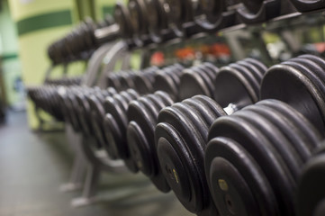 Rows of dumbbells in the gym