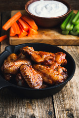 Roasted chicken wings with carrots, celery and dipping sauce