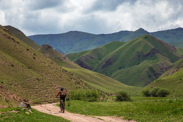A cyclist is traveling in the mountains