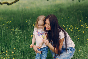 child near tree with mom