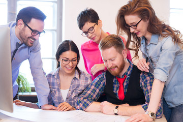 Coworkers working on project together in office
