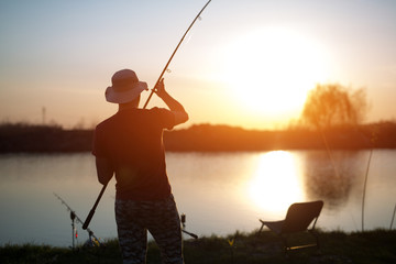 Fishing as recreation and sports displayed by fisherman at lake