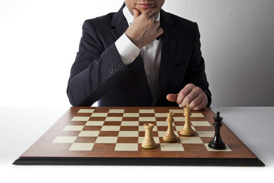 Playing chess. Businessman planing strategy