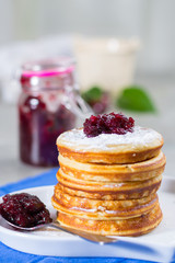 Homemade American pancakes served with red cranberry jam on blue napkin, Americal flag colors