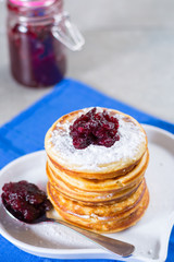 Homemade American pancakes served with red cranberry jam on blue napkin, Americal flag colors