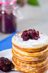 Homemade American pancakes served with red cranberry jam on blue napkin, Americal flag colors