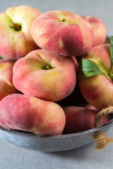Fresh ripe chinese flat saturn peaches with leaves