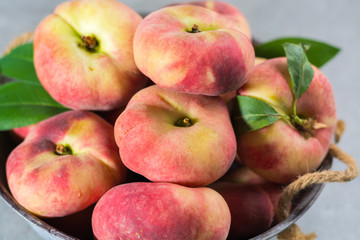 Fresh ripe chinese flat saturn peaches with leaves