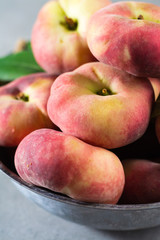 Fresh ripe chinese flat saturn peaches with leaves