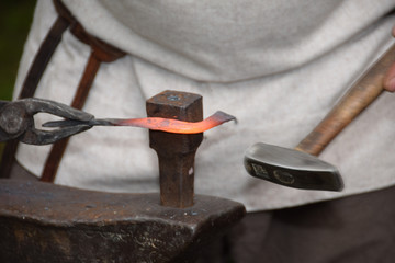 Blacksmith when working with a hammer in the open air