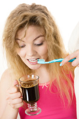 Fototapeta premium Happy woman holding toothbrush and coffee