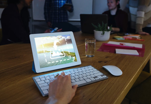 User with Tablet and Keyboard on Table Mockup 1