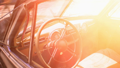 Interior of a classic vintage car. Close up on a dashboard  in the sunlight. (road, travel, retro concert)