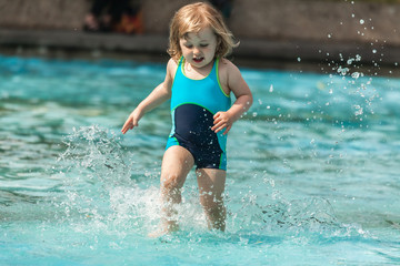 Little girl in a public pool for kids
