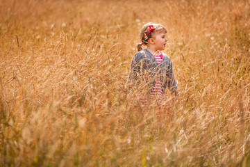 Little girl in the high grass