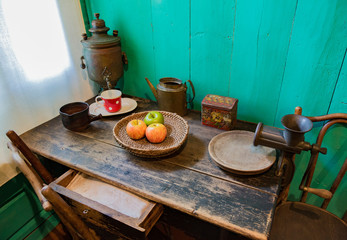 Vintage set for tea, apples and meat grinder on an old wooden table
