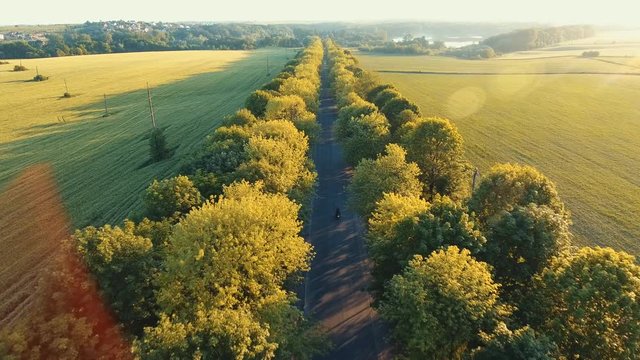 Aerial: the hills of the Carpathians, the camera follows a motorcyclist on the highway, having fun and enjoying the road