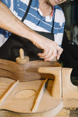 Man working at a Workshop with Musical instruments