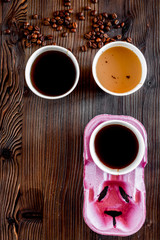 Coffee take away. Coffee cups with covers and coffee beans on wooden table backound top view copyspace