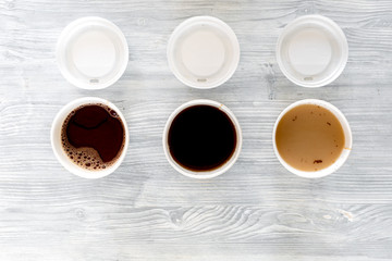 Coffee to go. Coffee cups with cover on wooden table backound top view copyspace