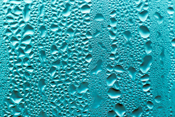 Background of water drops on the some surface in blue colors