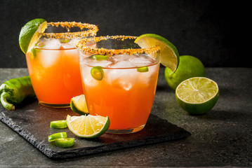 Alcohol. Traditional Mexican South American cocktail. Spicy michelada with hot jalapeno peppers and...