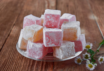 Delicious turkish delight on a wooden background