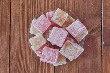 Delicious turkish delight on a wooden background