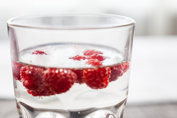 Sparkling raspberry lemonade water in a transparent glass