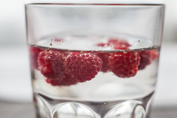 Sparkling raspberry lemonade water in a transparent glass