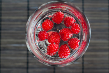 Sparkling raspberry lemonade water in a transparent glass