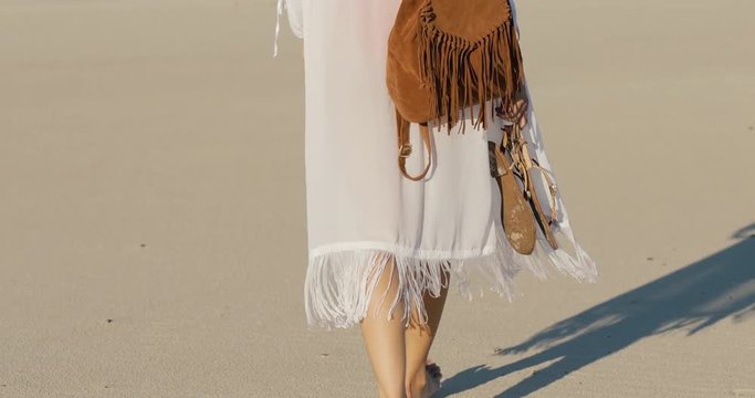 Trip alone. Woman walking away on a sand in desert.