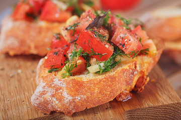 Bruschetta with chopped tomatoes, basil and herbs on grilled crusty bread.