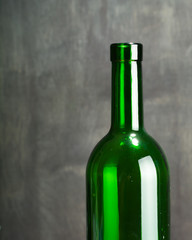 High wine glass made from green glass. No content. Side view. Low key.