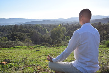 Man Meditating On Mountain