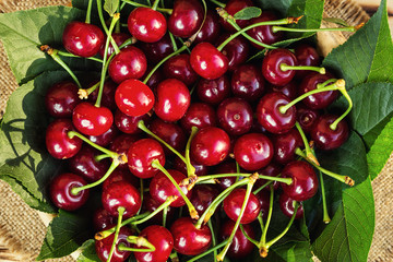 Cherries in basket on wooden table.Cherry. Cherries in bowl. Red cherry. Fresh sweet cherries with water drops,Close up.healthy food concept,soft focus
