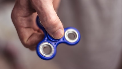 The hand holds the spinner