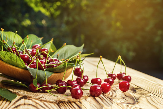 Cherries in basket on wooden table.Cherry. Cherries in bowl. Red cherry. Fresh sweet cherries with water drops,Close up.healthy food concept,soft focus