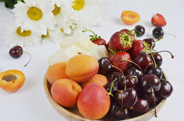 Healthy Fresh Breakfast Yogurt with Granola Fruits Berries Strawberries Apricot Melon Cherry Chamomile Close up White Background
