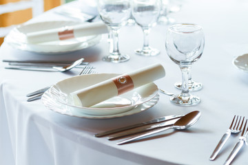 table setting with spoon, knife, plates and glass