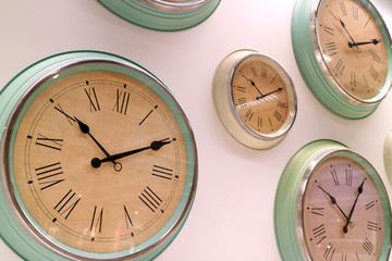 Different type of retro style wall clocks on the wall 
