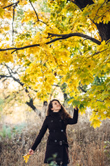 girl walks in beautiful autumn park