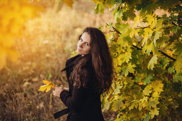 girl walks in beautiful autumn park