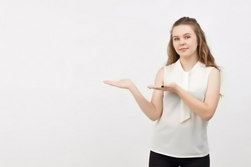 Portrait of young woman pointing hands finger at corner with copyspace isolated on a white background.Woman with finger point up