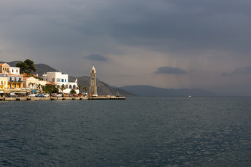 Gulf in small typical island Symi with bright houses in Greece