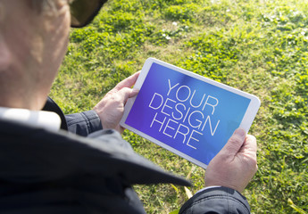 Senior Tablet User Outside Mockup 1 - Powered by Adobe