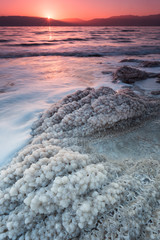 Sunrise over the dead sea with salt crystals